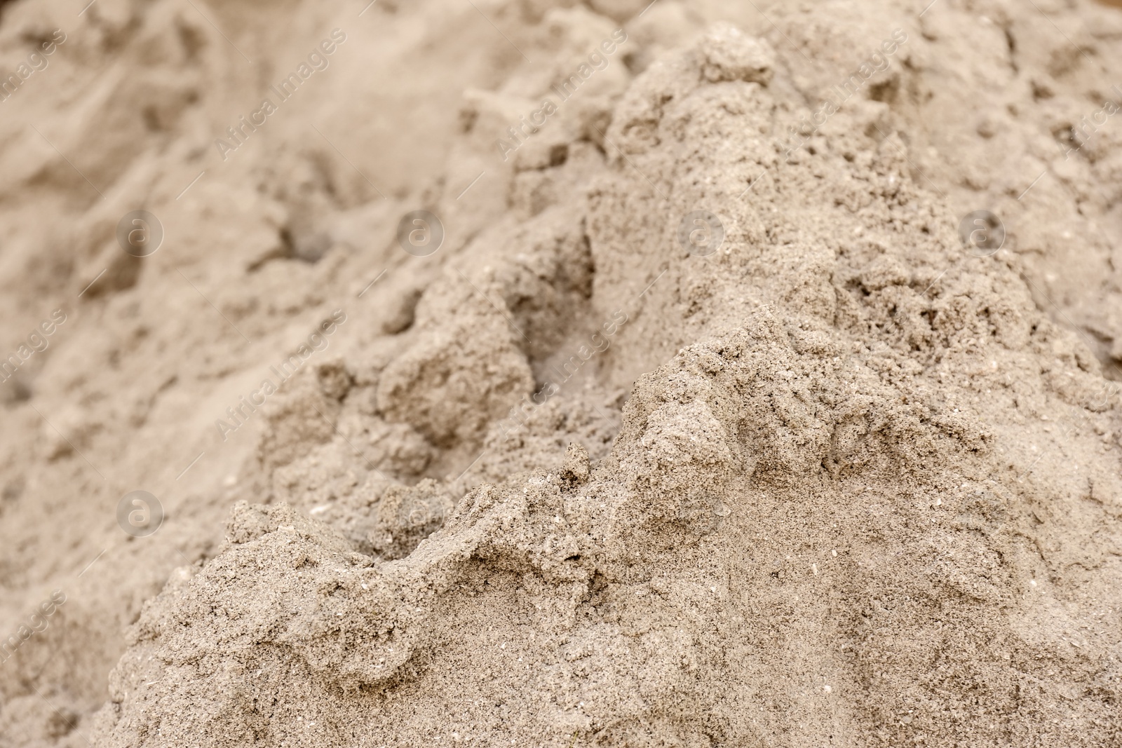 Photo of Textured sandy soil surface as background, closeup