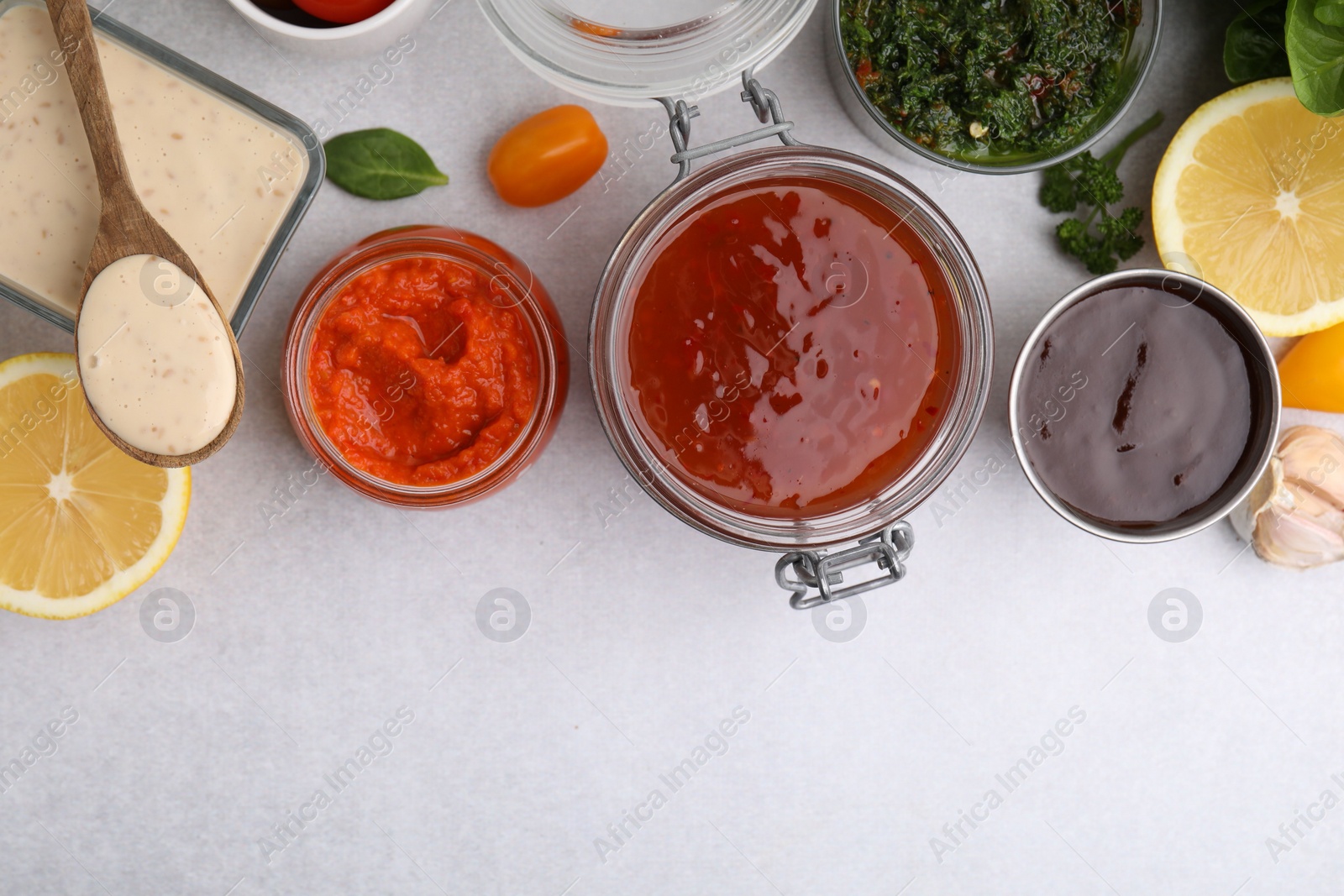 Photo of Different marinades and products on light table, flat lay. Space for text