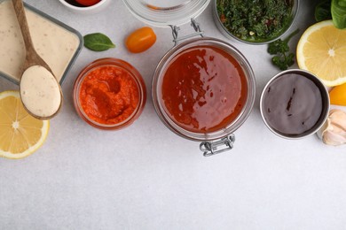 Photo of Different marinades and products on light table, flat lay. Space for text