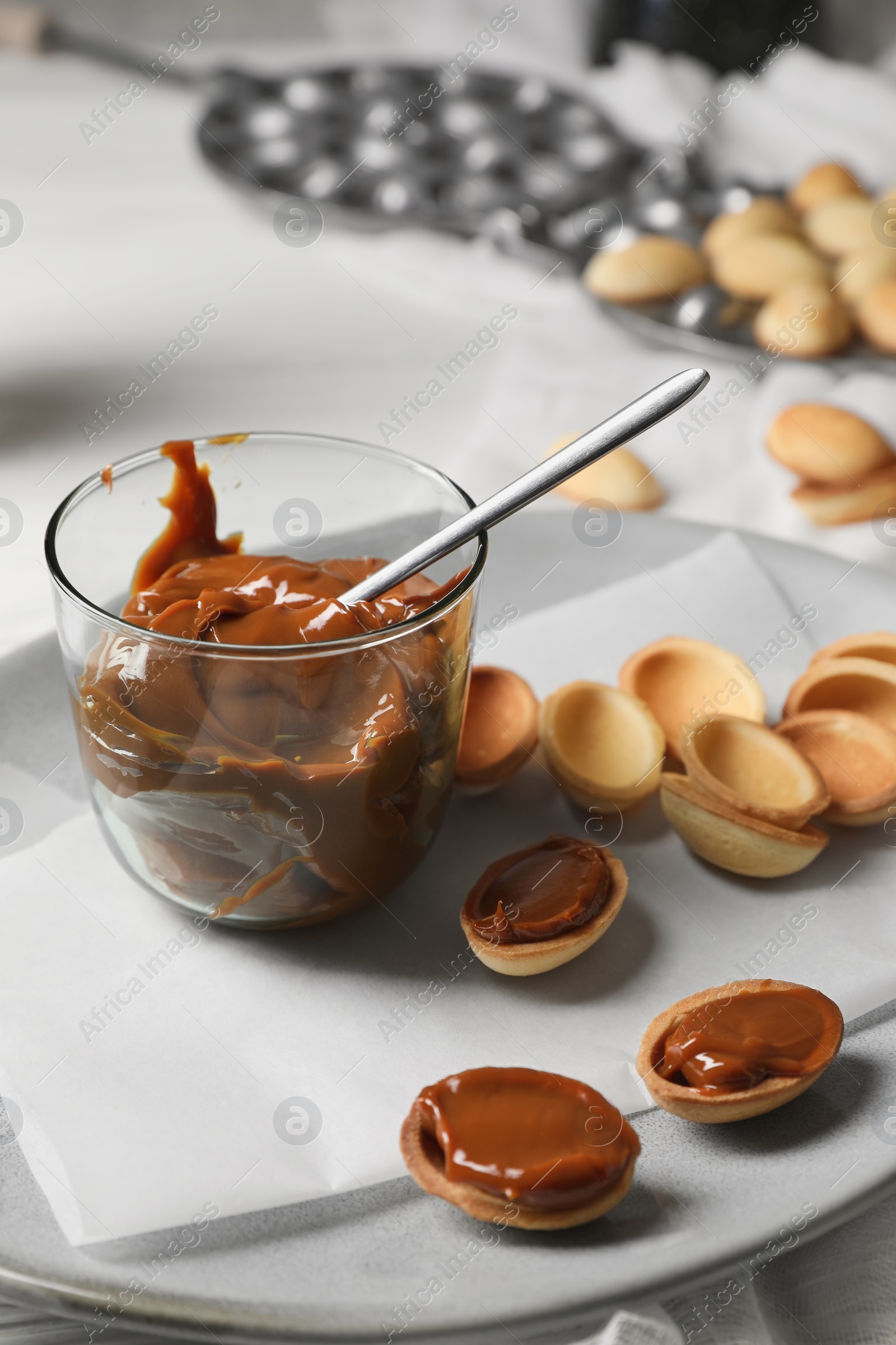 Photo of Delicious walnut shaped cookies with condensed milk on table