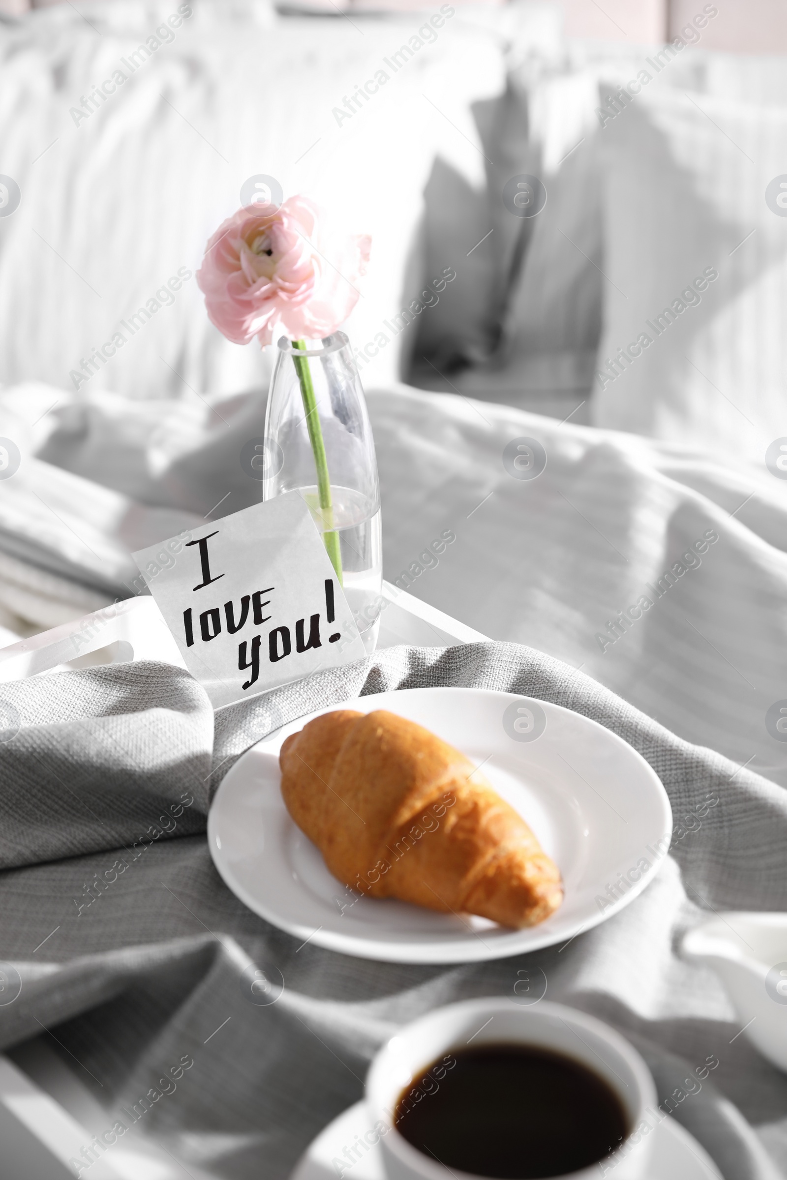 Photo of Romantic breakfast with note saying I Love You on bed