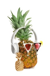 Photo of Funny pineapple with headphones and party glasses on white background