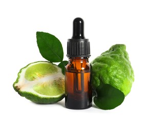 Photo of Bottle of essential oil, fresh bergamot fruits and leaves on white background