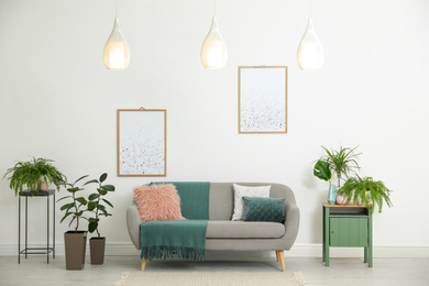 Photo of Soft pillows on grey sofa in living room