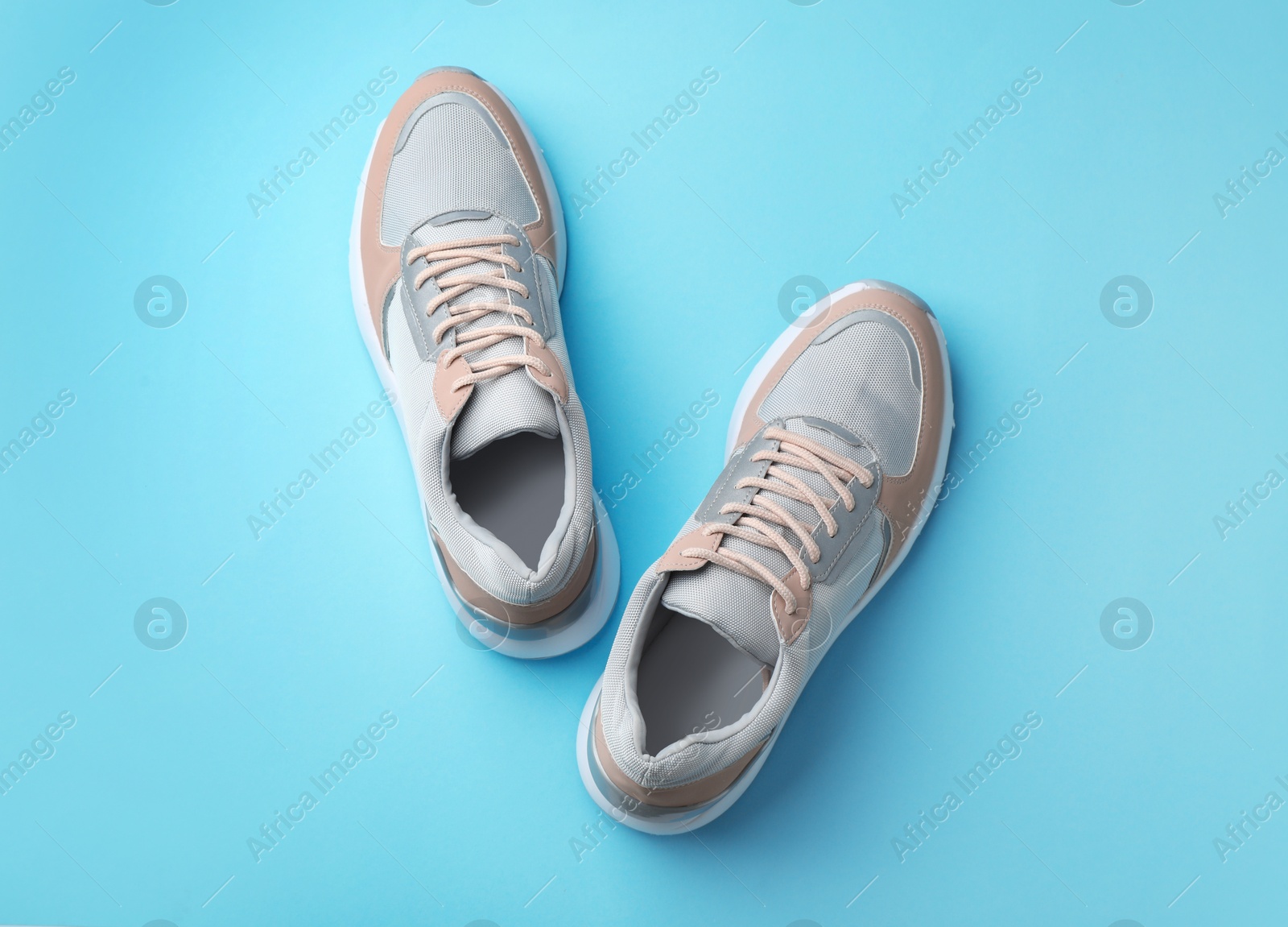 Photo of Pair of stylish sneakers on color background, top view