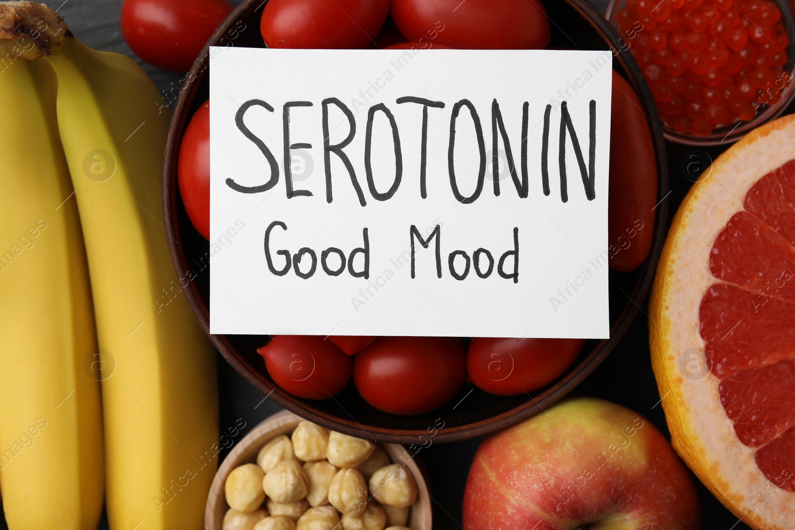 Photo of Many different products and card with phrase Serotonin Good Mood on table, flat lay. Natural antidepressants