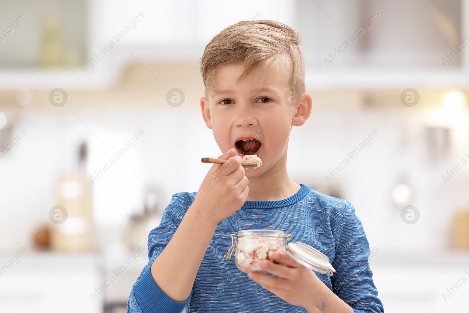 Photo of Little boy with yogurt on blurred background