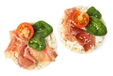 Puffed rice cakes with prosciutto, tomato and basil isolated on white, top view