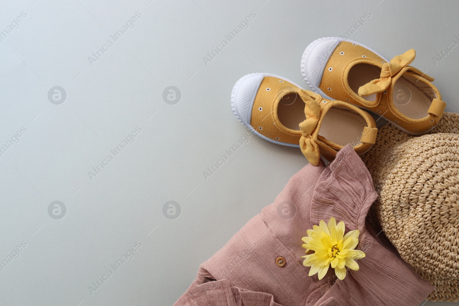 Photo of Stylish child clothes, shoes and hat on grey background, flat lay. Space for text