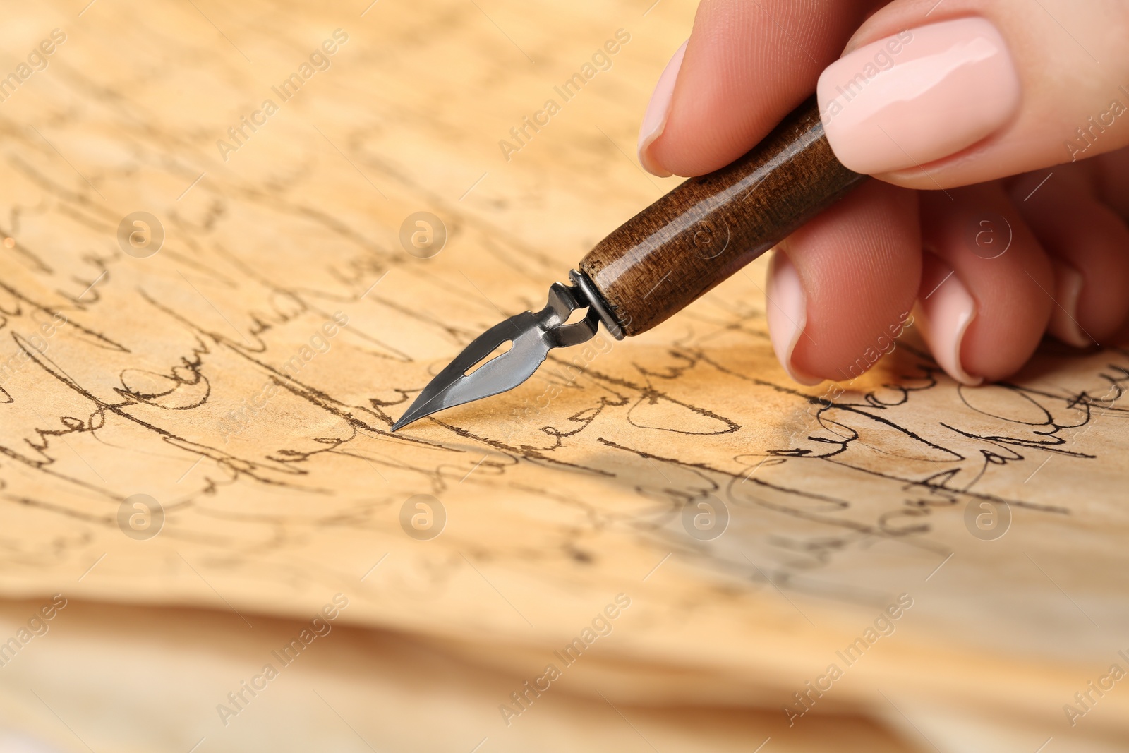 Photo of Woman writing letter with fountain pen, closeup