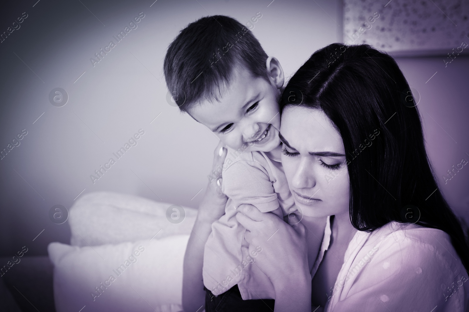 Image of Depressed single mother with child at home, color toned