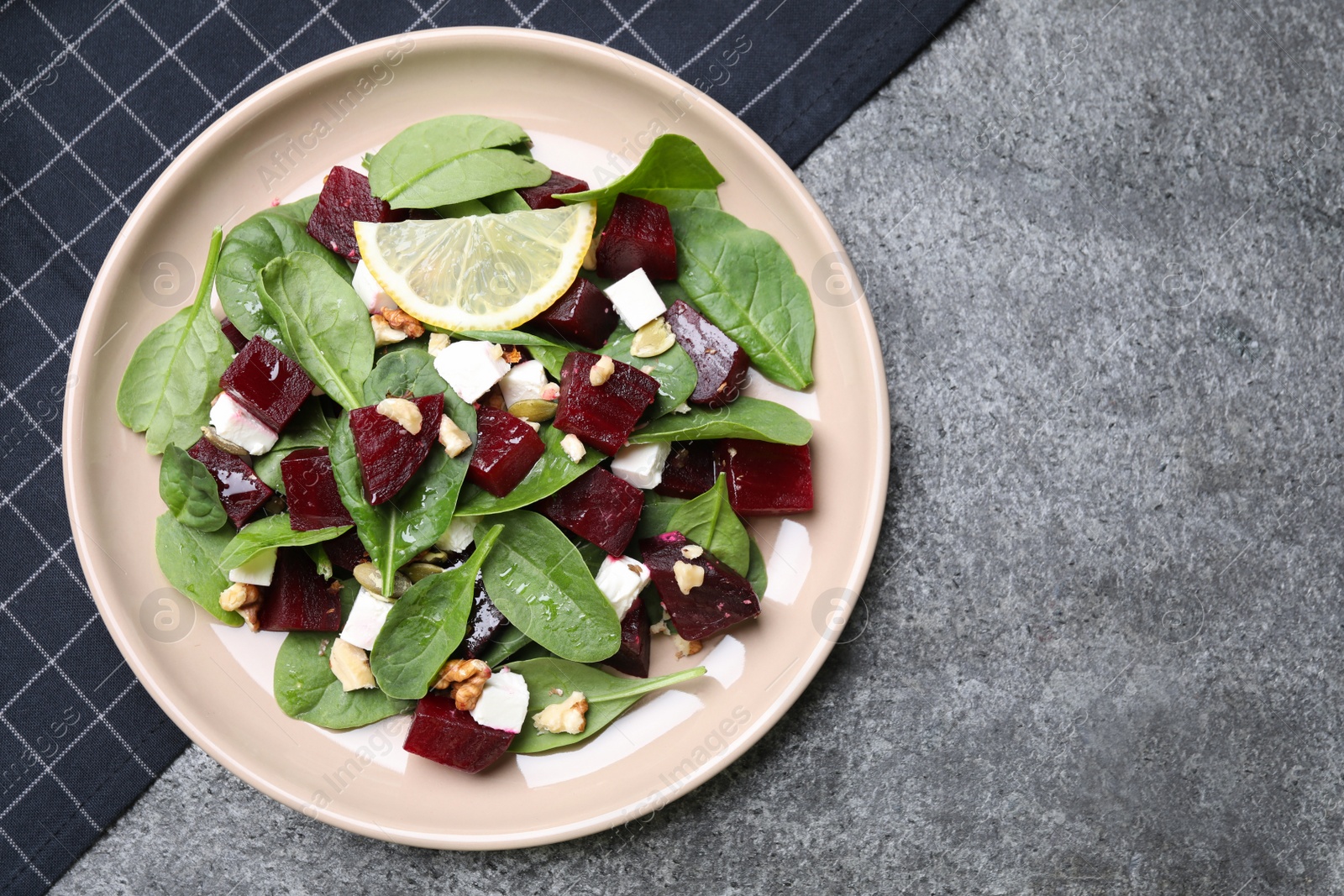 Photo of Delicious beet salad served on grey table, top view