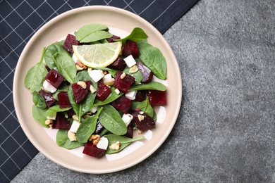 Delicious beet salad served on grey table, top view