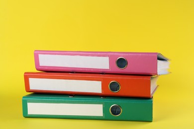 Photo of Stack of office folders on yellow background