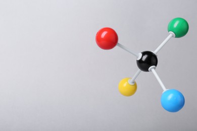 Photo of Molecular atom model on light grey background, space for text. Chemical structure