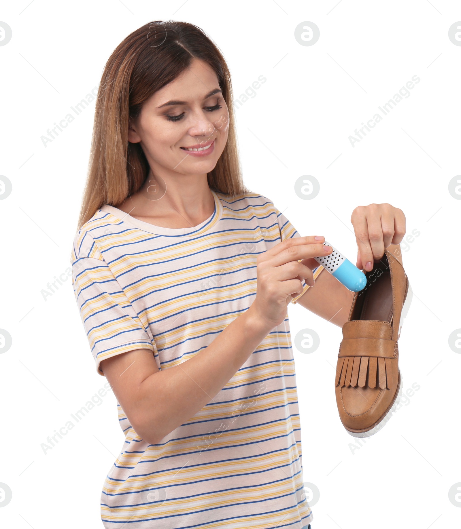 Photo of Woman putting capsule shoe freshener in footwear on white background