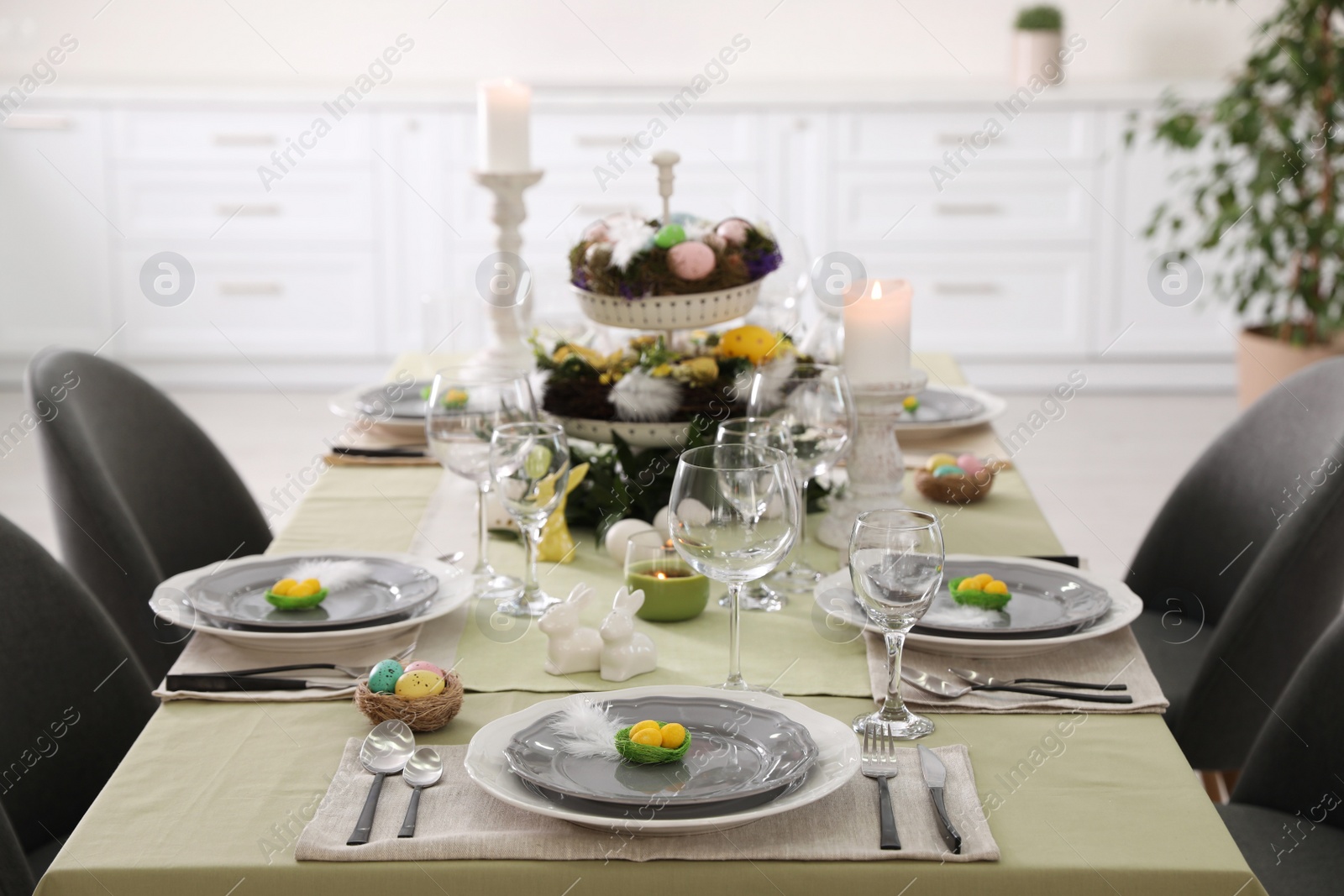 Photo of Beautiful Easter table setting with burning candles indoors