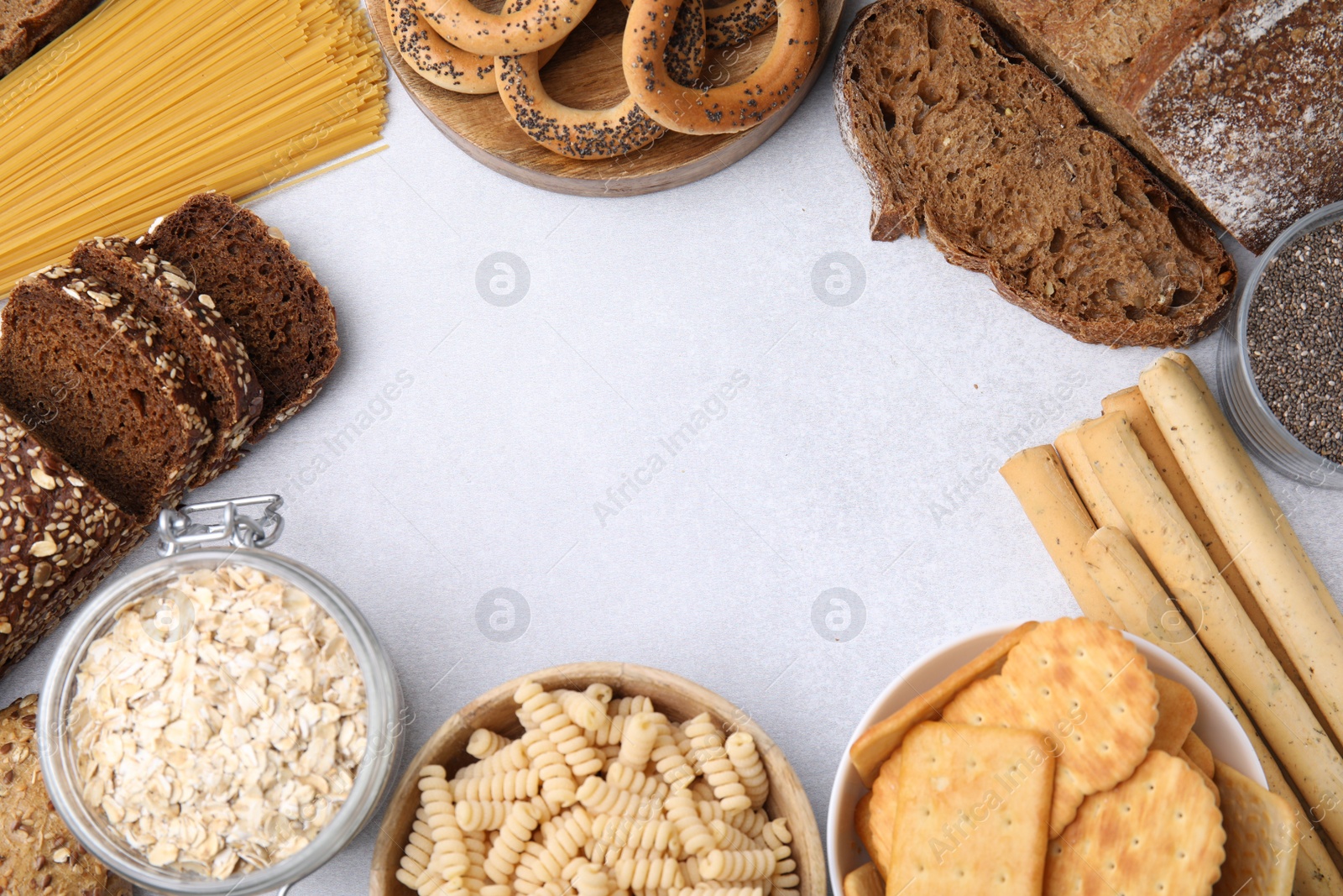 Photo of Frame made of different gluten free products on white table, flat lay. Space for text