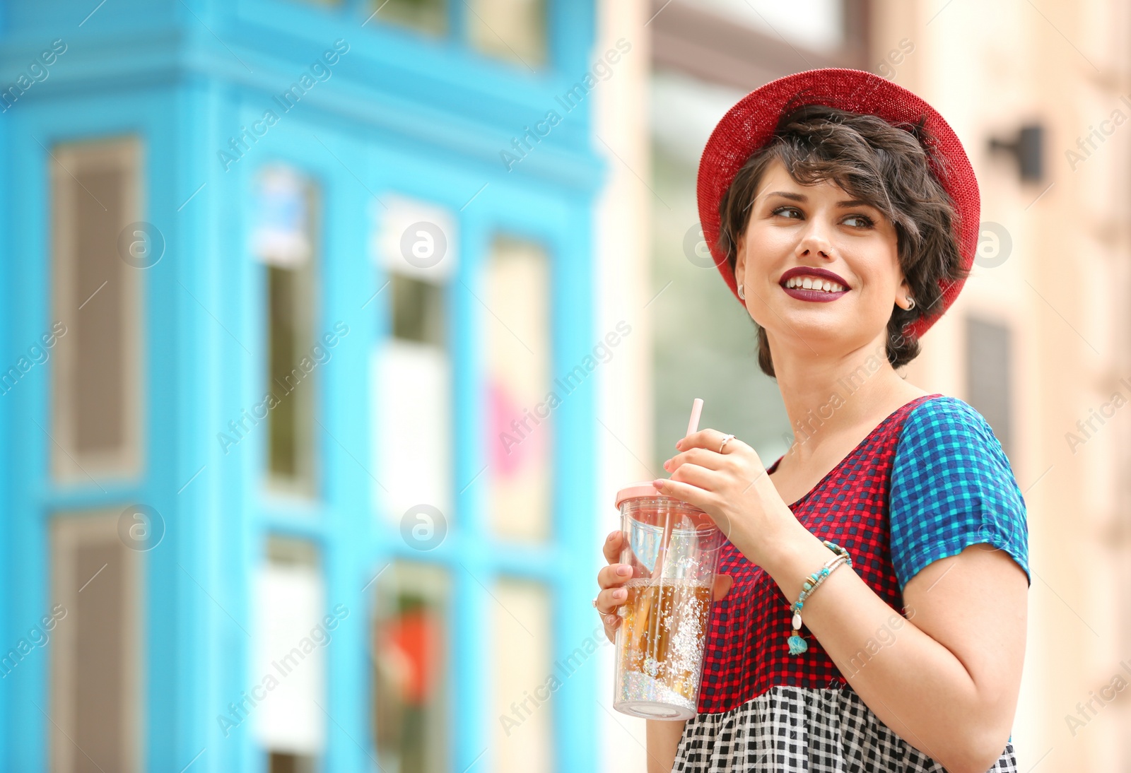 Photo of Young woman with cup of tasty lemonade outdoors