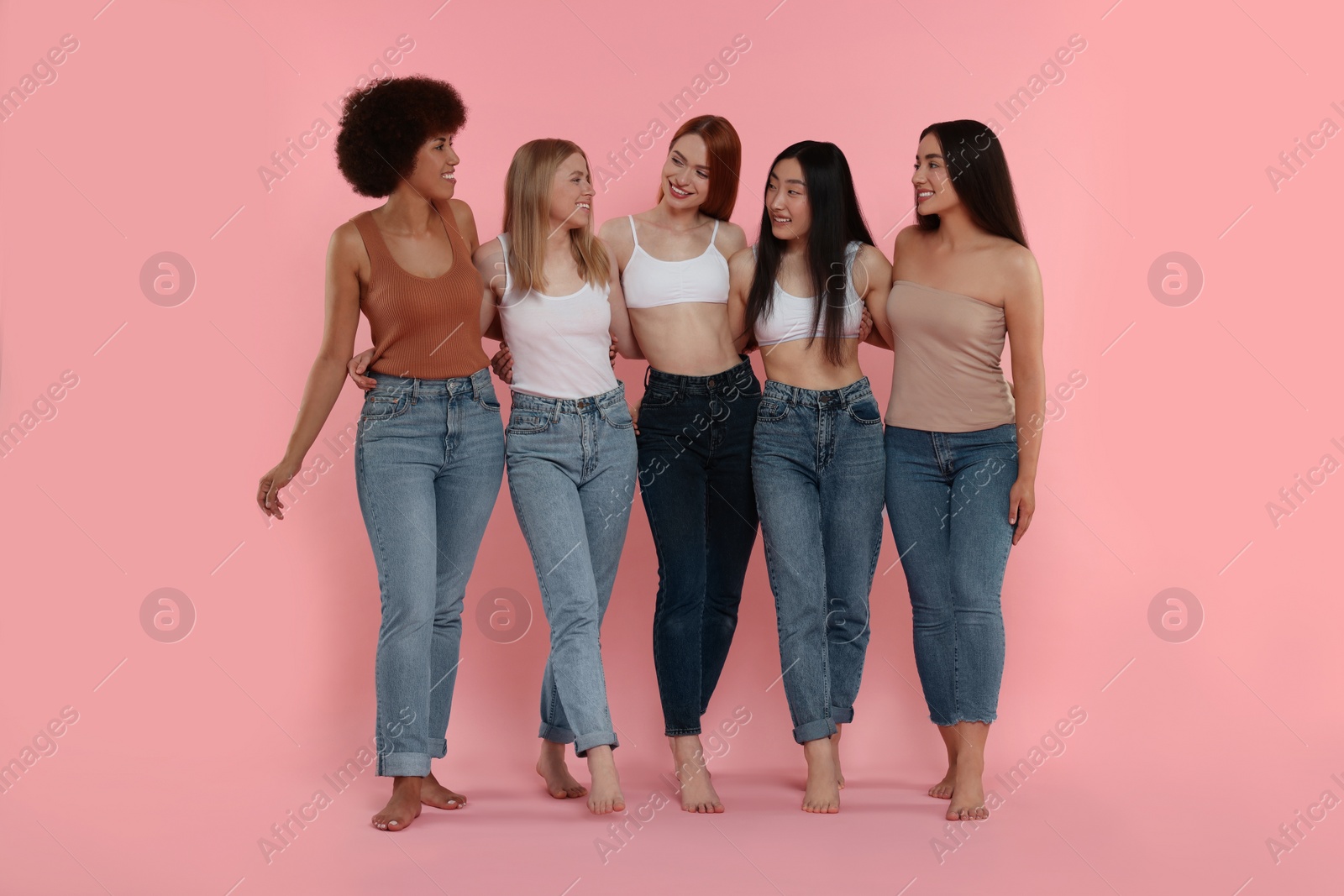 Photo of Group of beautiful young women on pink background