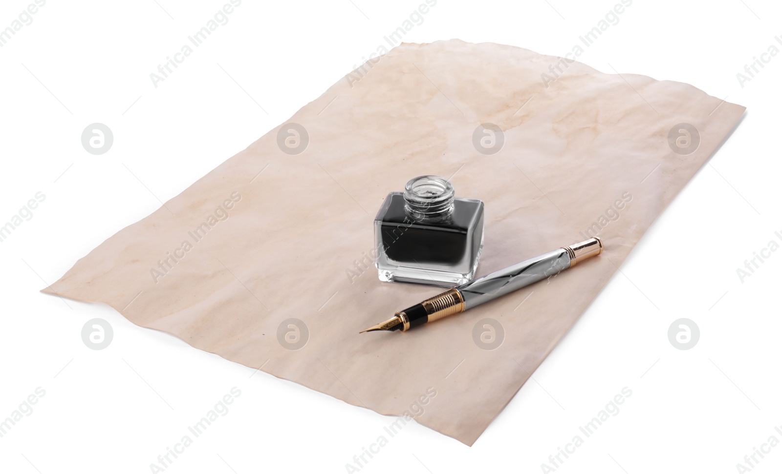 Photo of Inkwell, fountain pen and parchment on white background