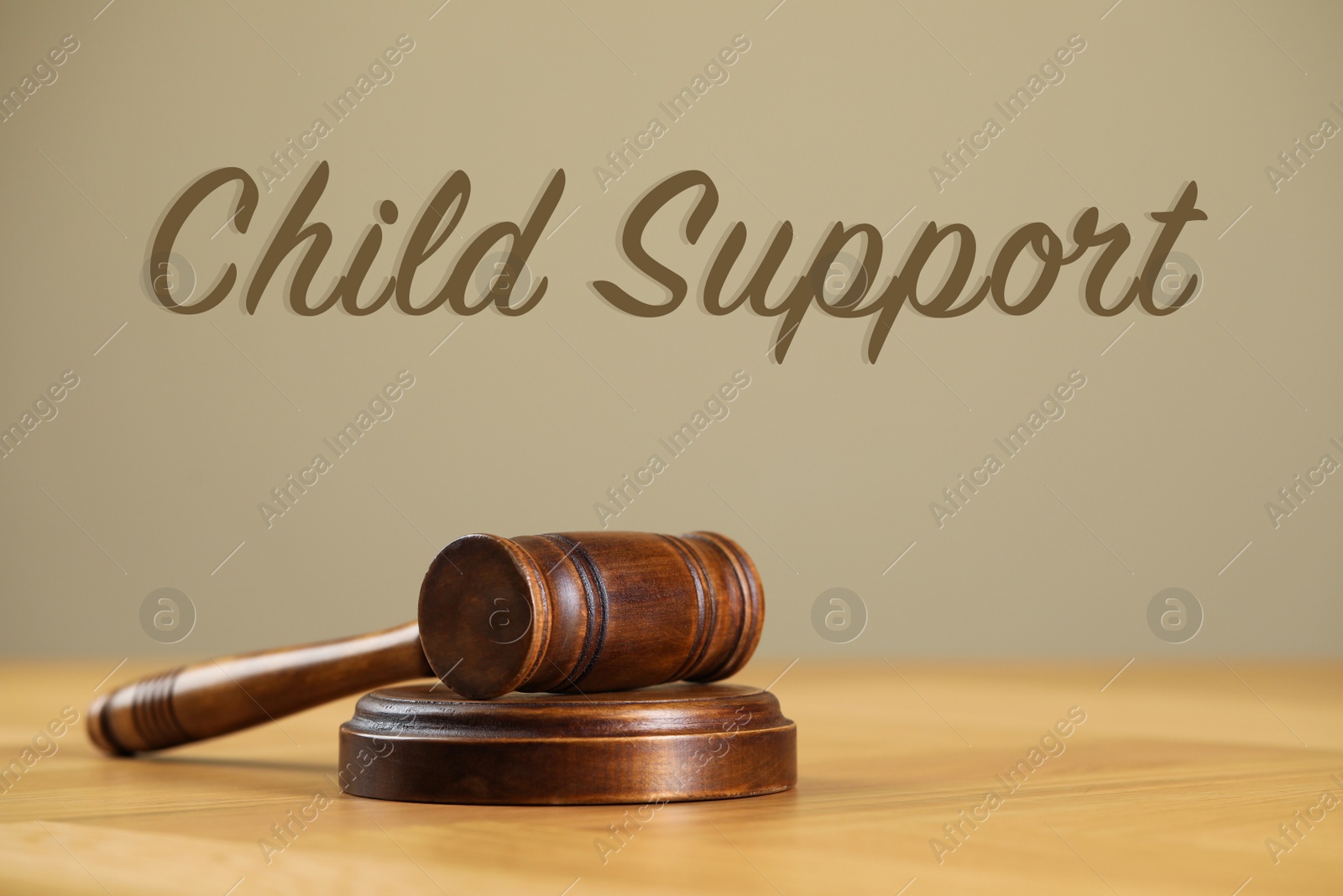 Image of Judge's gavel on wooden table. Child support concept