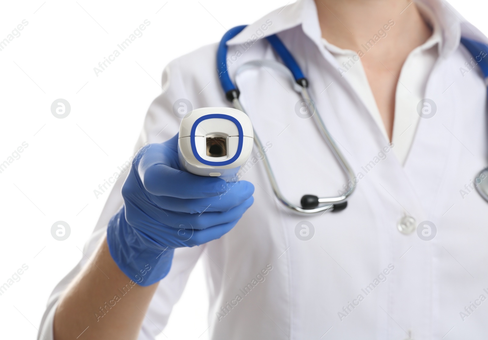 Photo of Doctor in latex gloves holding non contact infrared thermometer on white background, closeup. Measuring temperature