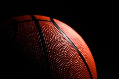 Photo of One basketball ball on black background, closeup