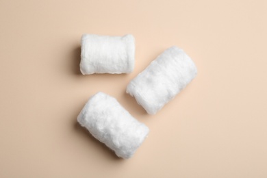 Photo of Three fluffy cotton rolls on color background, flat lay