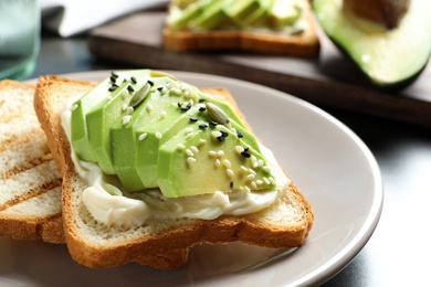 Photo of Toasted bread with avocado and seeds on plate