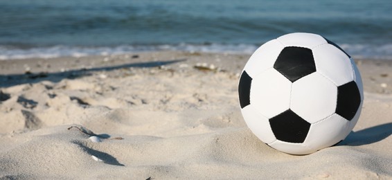 Photo of Soccer ball on beach, space for text. Football equipment