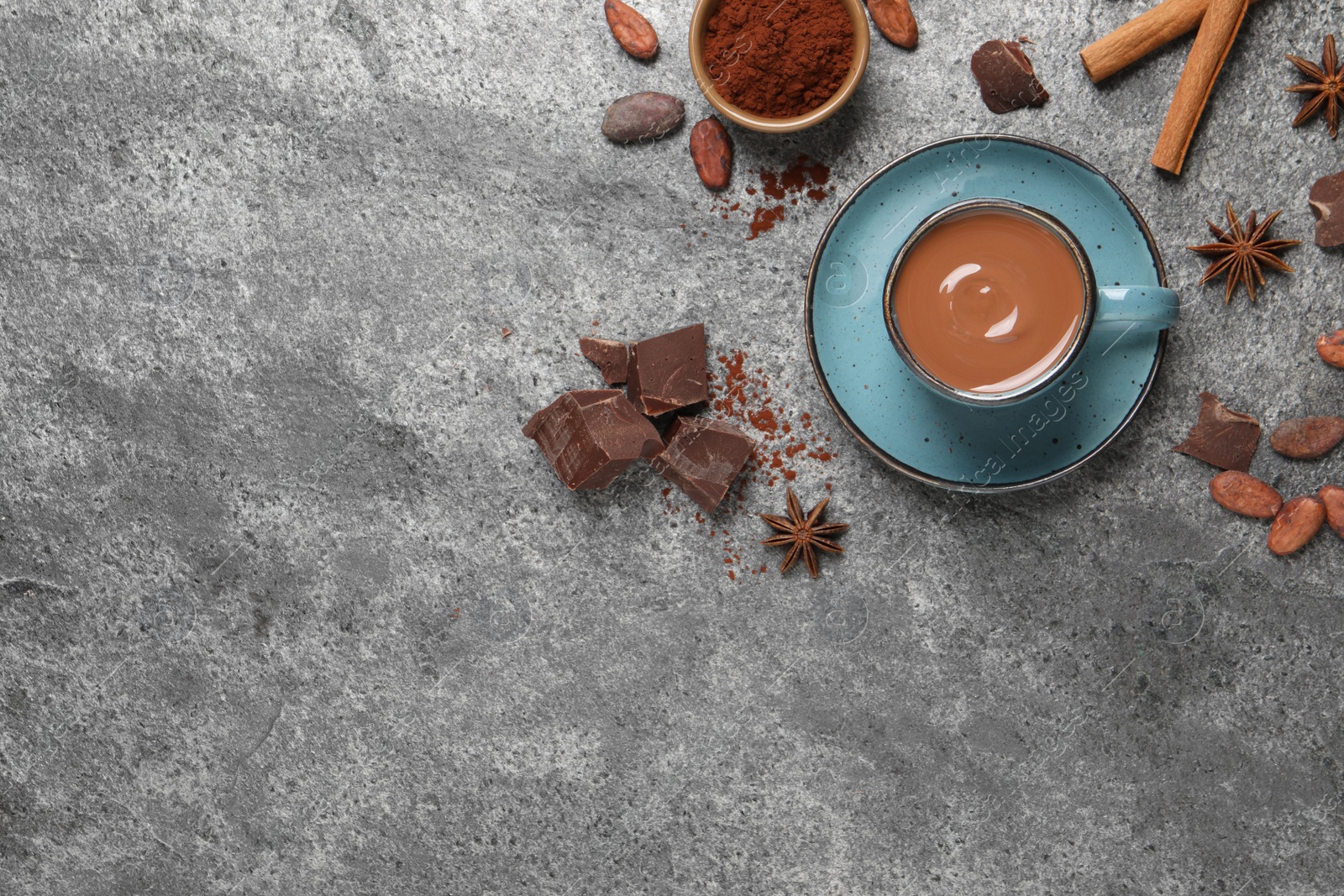 Photo of Flat lay composition with yummy hot chocolate on grey table. Space for text