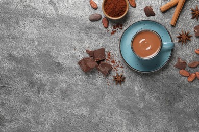 Flat lay composition with yummy hot chocolate on grey table. Space for text