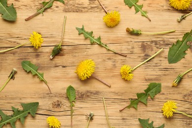 Flat lay composition with beautiful yellow dandelions on wooden table
