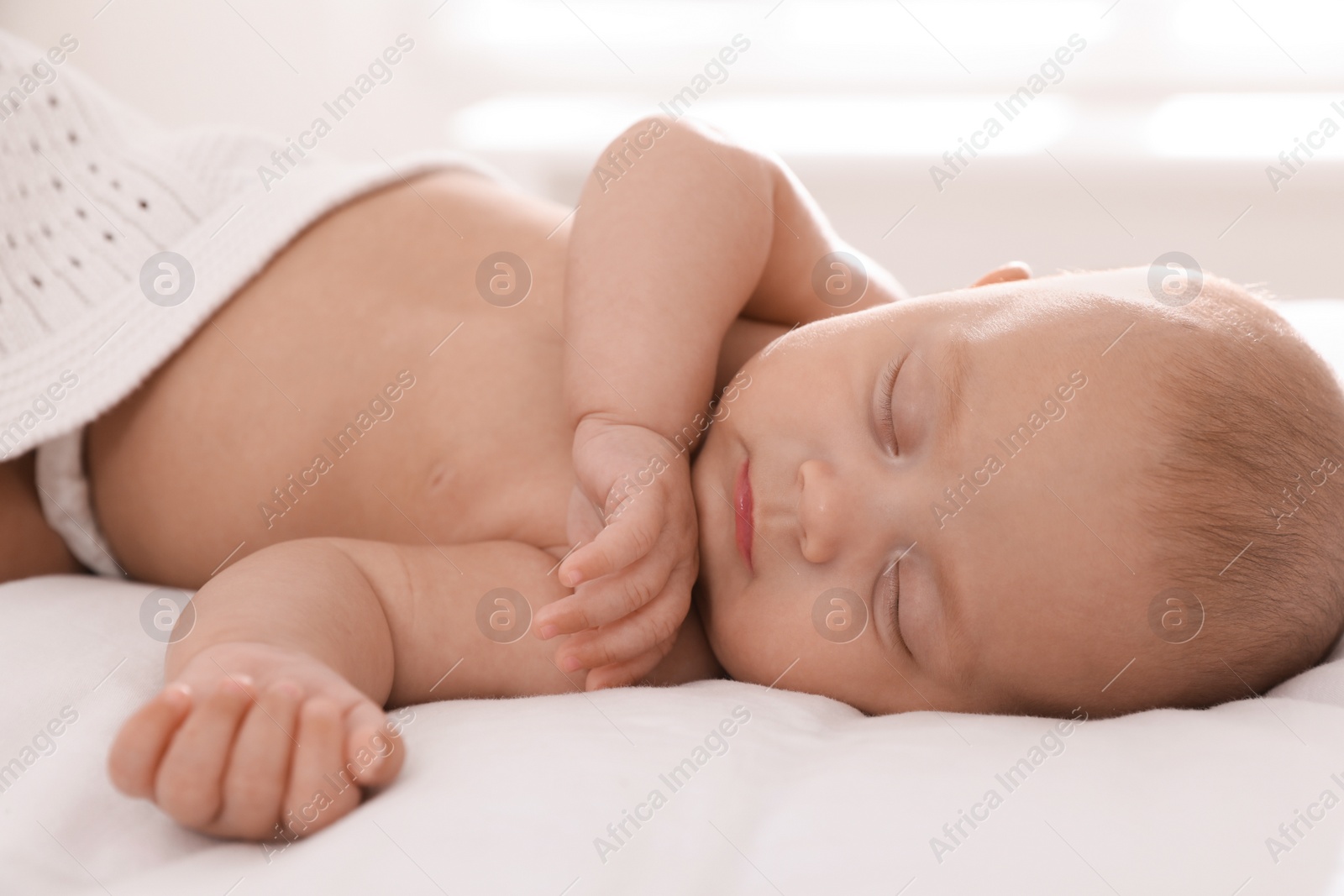 Photo of Cute little baby sleeping in bed at home, closeup