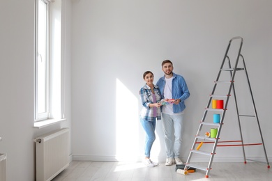 Photo of Young couple with color palette indoors