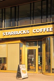 WARSAW, POLAND - MARCH 22, 2022: Starbucks coffee shop on city street
