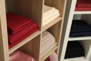 Photo of Different colorful bed linens on display in home textiles store