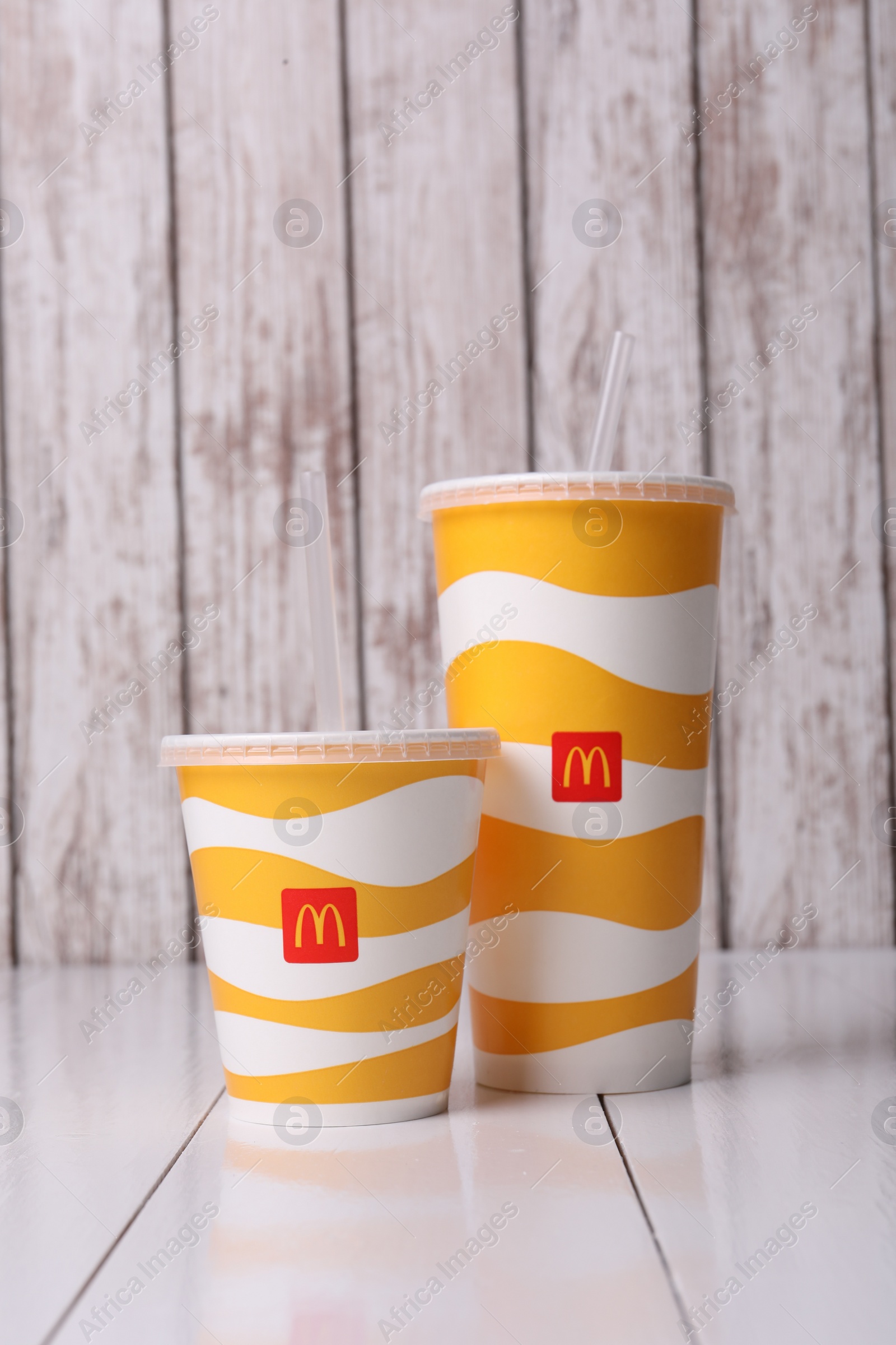 Photo of MYKOLAIV, UKRAINE - AUGUST 12, 2021: Cold McDonald's drinks on white wooden table