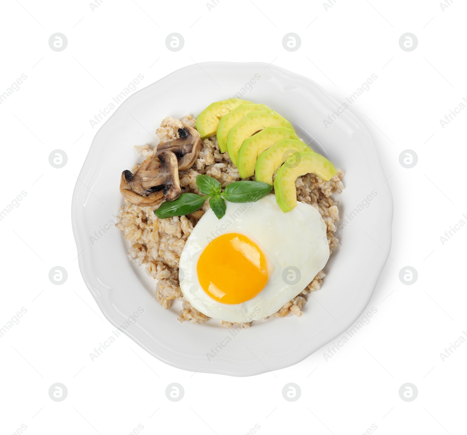 Photo of Tasty boiled oatmeal with fried egg, avocado and mushrooms isolated on white, top view