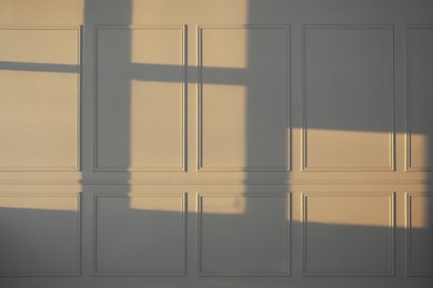 Photo of Light and shadows from window on wall indoors