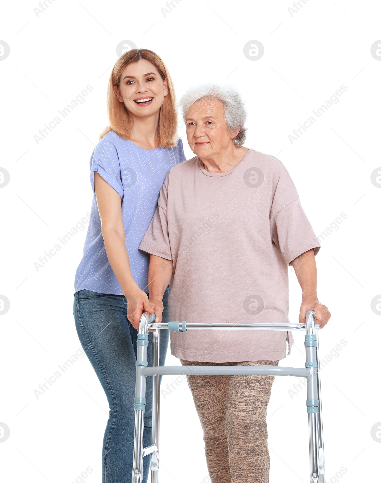 Photo of Caretaker helping elderly woman with walking frame on white background