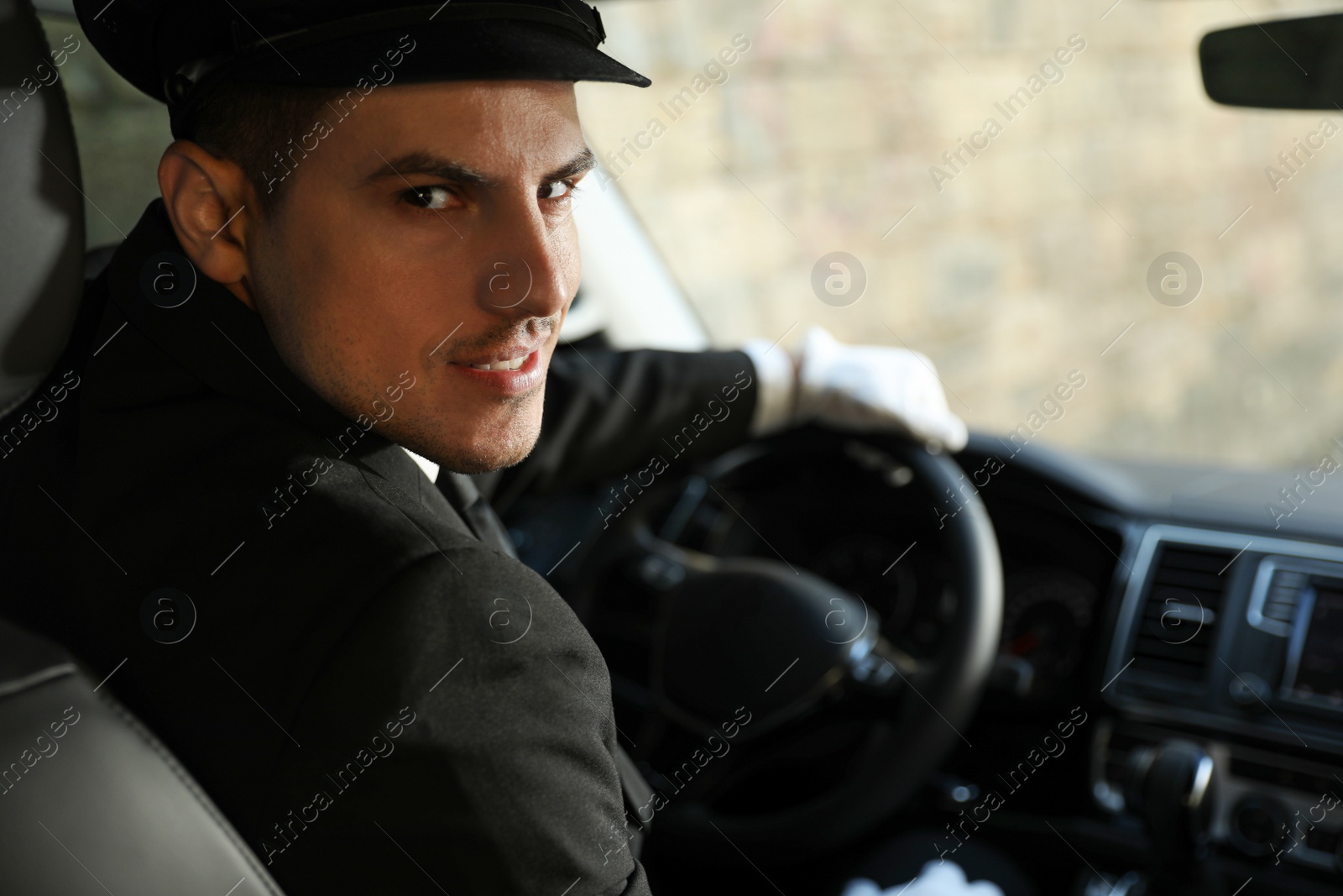 Photo of Professional driver in luxury car. Chauffeur service