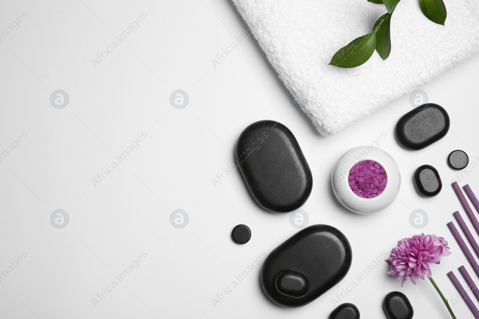 Photo of Composition with spa stones on white background, top view. Space for text