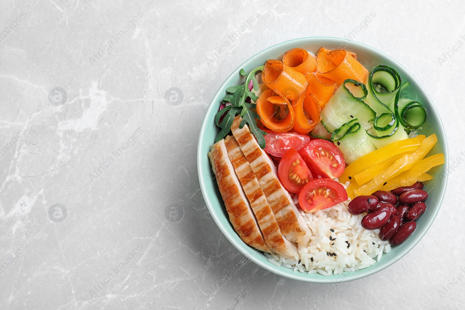 Photo of Tasty rice with beans on light grey marble table, top view. Space for text