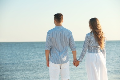 Photo of Happy young couple resting together on beach