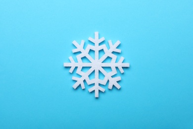 Photo of Beautiful decorative snowflake on light blue background, top view