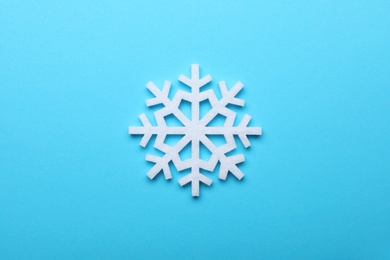 Beautiful decorative snowflake on light blue background, top view