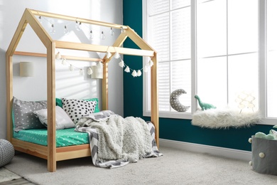 Photo of Cozy child room interior with comfortable bed