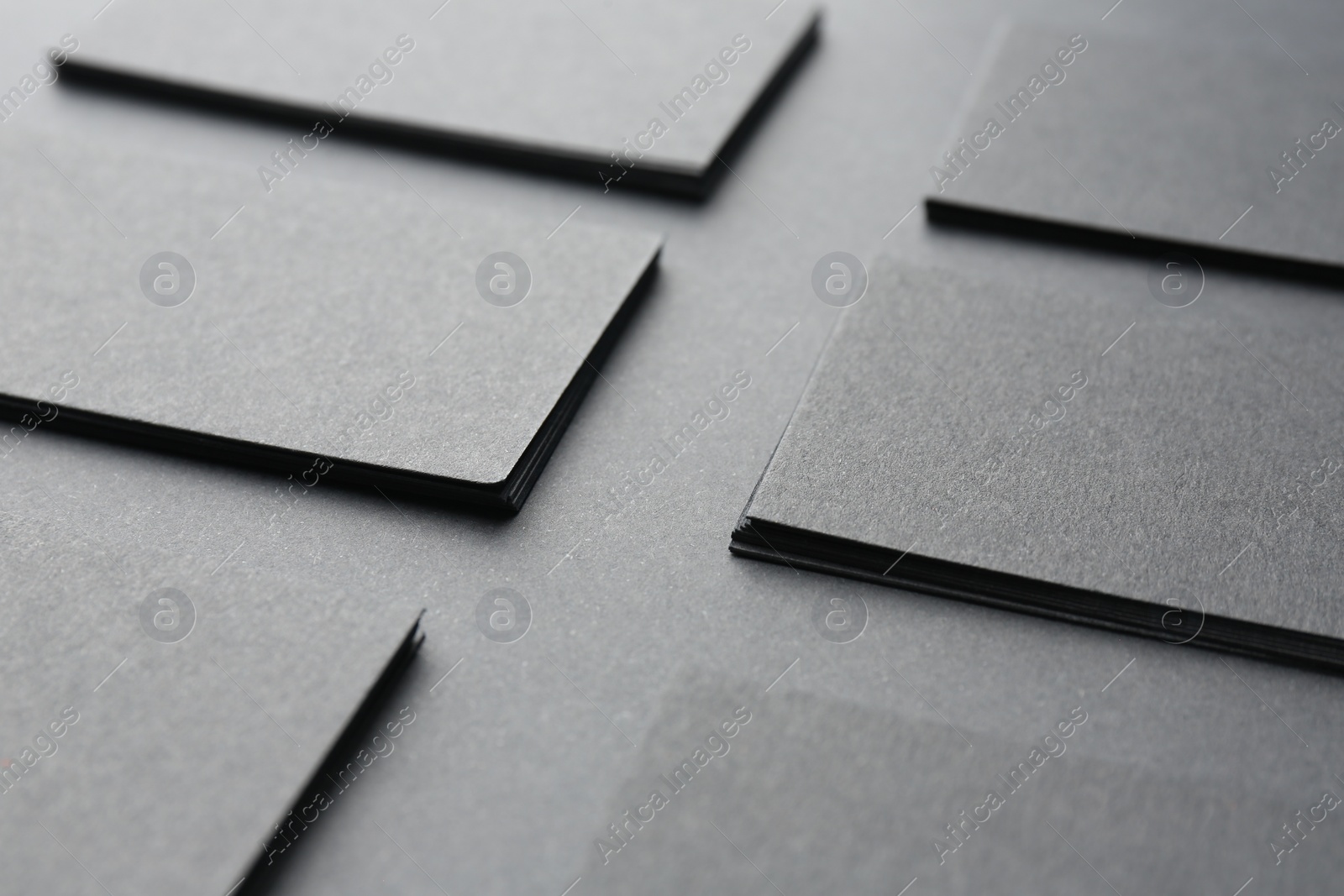 Photo of Blank business cards on black background, closeup. Mockup for design